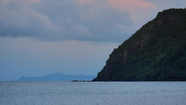 Static shot to Siam bay islands, calm scene landscape with islands under sunset sky and calm water surface
