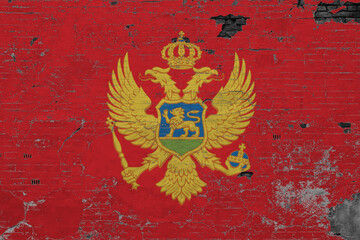 Montenegro flag on grunge scratched concrete surface. National vintage background. Retro wall concept.