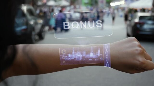 Female hand activates conceptual HUD holograms on smart bracelet with text Bonus. Unrecognizable woman with holographic technology on a city street background