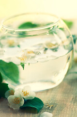 round glass vase with jasmine flowers float in the water. selective focus ,