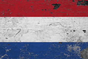 Netherlands flag on grunge scratched concrete surface. National vintage background. Retro wall concept.