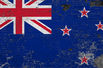 New Zealand flag on grunge scratched concrete surface. National vintage background. Retro wall concept.
