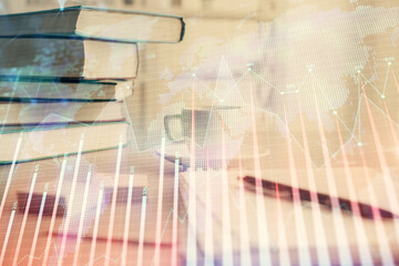 Double exposure of financial chart drawing and desktop with coffee and items on table background. Concept of forex market trading