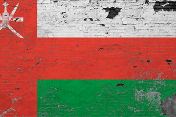 Oman flag on grunge scratched concrete surface. National vintage background. Retro wall concept.
