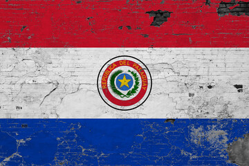 Paraguay flag on grunge scratched concrete surface. National vintage background. Retro wall concept.