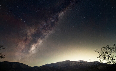 The milky way galaxy shining behind the Coastal mountain range of Central Chile.