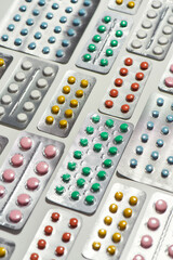 Composition with many medical pills, tablets pack in blister lying diagonally over white background. Health care, vitamins and treatment concept