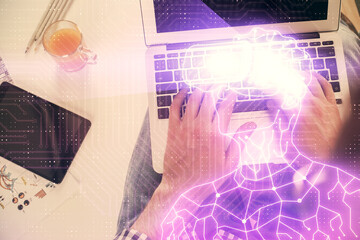 Double exposure of man's hands typing over computer keyboard and virtual reality hologram drawing. Top view. Technology concept. Future.