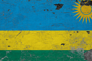 Rwanda flag on grunge scratched concrete surface. National vintage background. Retro wall concept.
