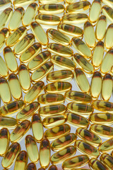 Top view of fish oil, omega 3 gel capsules scattered, lying randomly. Health care, vitamins and treatment concept