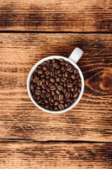 Roasted coffee beans in white cup