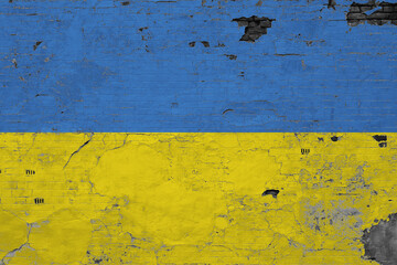 Ukraine flag on grunge scratched concrete surface. National vintage background. Retro wall concept.