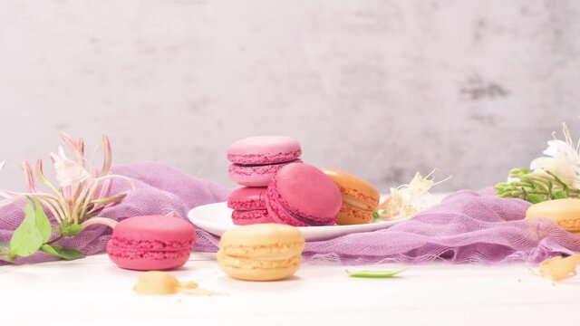 A french sweet delicacy, macaroons variety closeup. Color fresh macarroons on wooden bacground