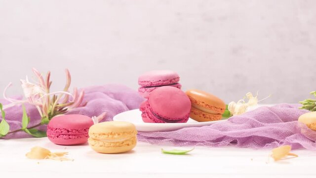 A french sweet delicacy, macaroons variety closeup. Color fresh macarroons on wooden bacground