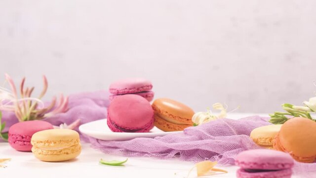 A french sweet delicacy, macaroons variety closeup. Color fresh macarroons on wooden bacground