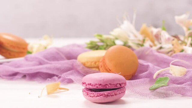A french sweet delicacy, macaroons variety closeup. Color fresh macarroons on wooden bacground