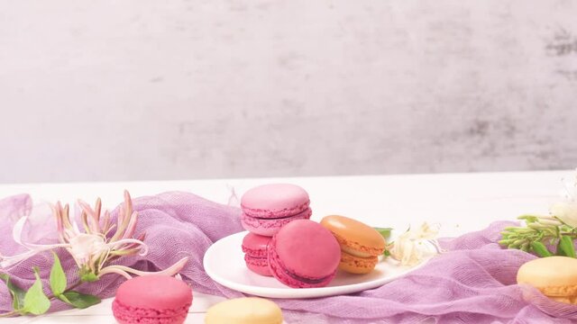 A french sweet delicacy, macaroons variety closeup. Color fresh macarroons on wooden bacground
