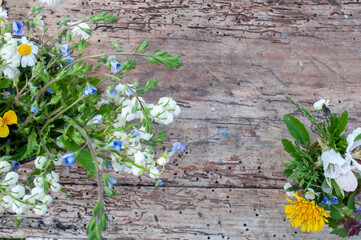 bouquet of daisies in a glass vase on a wooden background. place for text