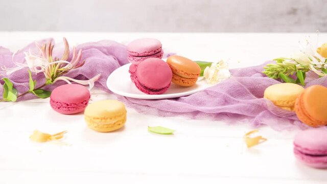 A french sweet delicacy, macaroons variety closeup. Color fresh macarroons on wooden bacground