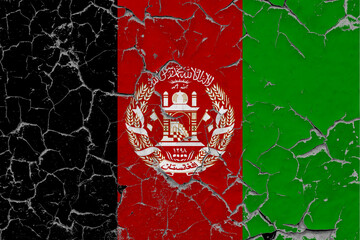 Afghanistan flag close up grungy, damaged and scratched on wall peeling off paint to see inside surface. Vintage National Concept.