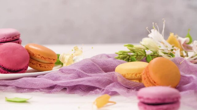 A french sweet delicacy, macaroons variety closeup. Color fresh macarroons on wooden bacground