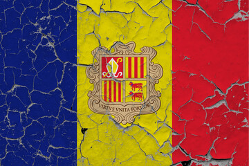 Andorra flag close up grungy, damaged and scratched on wall peeling off paint to see inside surface. Vintage National Concept.