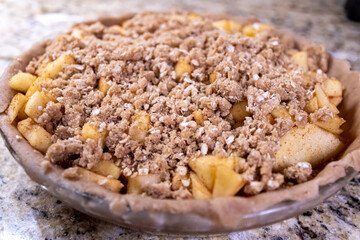 Apple pie with crumble crust ready to be baked