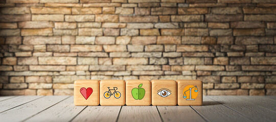 cubes with health icons in front of a brick wall on a wooden floor