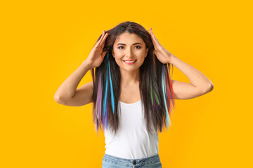 Fototapeta premium Beautiful young woman with unusual hair on color background