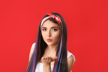 Beautiful young woman with unusual hair on color background