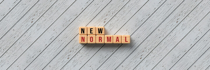 cubes with message NEW NORMAL on wooden background