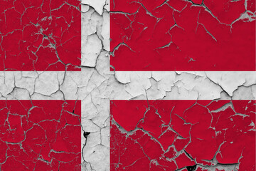 Denmark flag close up grungy, damaged and scratched on wall peeling off paint to see inside surface. Vintage National Concept.