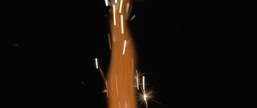 Fire and orange sparks coming out of a firework. Holiday, celebration, new year, christmas, birthday concept. Shallow DOF, close up, BMPCC 4K