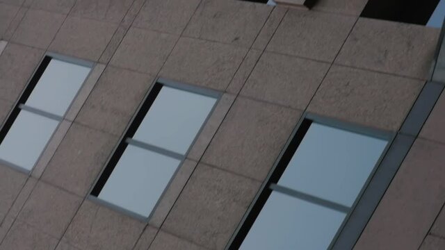 MONTREAL, CANADA - MARCH 14 2019 Dutch angle tracking shot from street view of tall shiny condo buildings on renee levesque street downtown montreal..