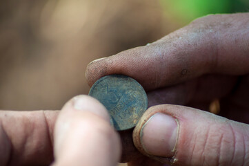 close-up old soviet coin found in the ground with a metal detector in the fingers. 3-copeck Soviet...
