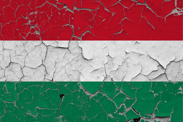 Hungary flag close up grungy, damaged and scratched on wall peeling off paint to see inside surface. Vintage National Concept.