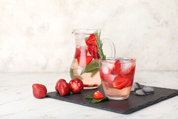 Glassware of fresh strawberry lemonade on table