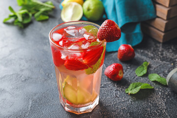 Glass of fresh strawberry lemonade on table
