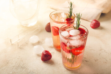 Glasses of fresh strawberry lemonade on table
