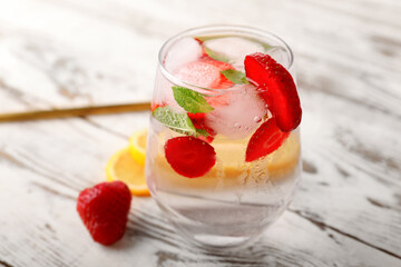 Glass of fresh strawberry lemonade on table