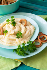 Golden mashed potatoes with parsley, decorated with bublik