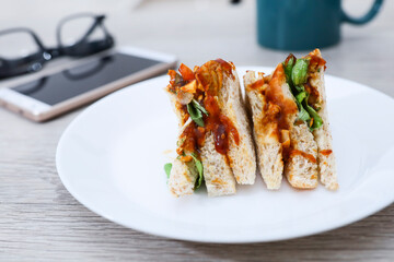 Grilled chicken sandwiches on a white plate 