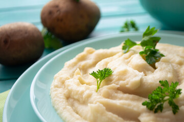 Rustic mashed potatoes with greens in bowl close up