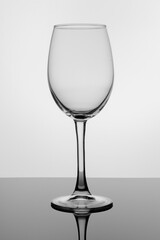 transparent glass stands on black glass on a white background