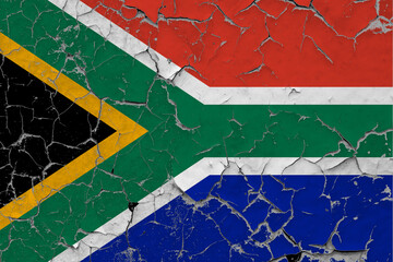 South Africa flag close up grungy, damaged and scratched on wall peeling off paint to see inside surface. Vintage National Concept.