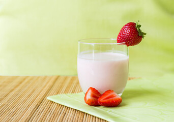 glass with healthy homemade strawberry smoothie and fresh strawberry decoration
