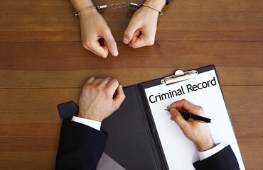 Police officer examining criminal record at desk, top view - obrazy, fototapety, plakaty