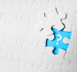 Fototapeta premium White puzzle with missing piece and question mark on white background, top view