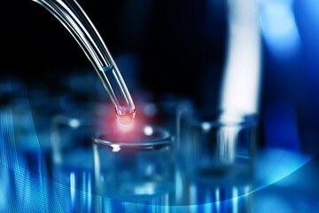 Dripping liquid into test tube, closeup. Laboratory analysis