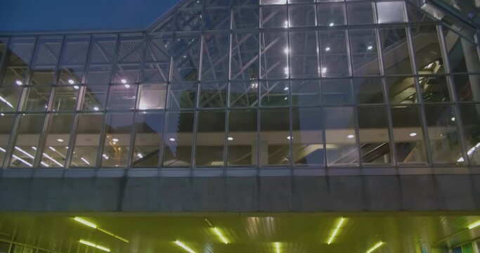 Montreal, QC, Canada - April 15, 2017: Worm eye view of Palais des Congres building with dusk blue sky, filmed while driving underpass on Avenue Viger